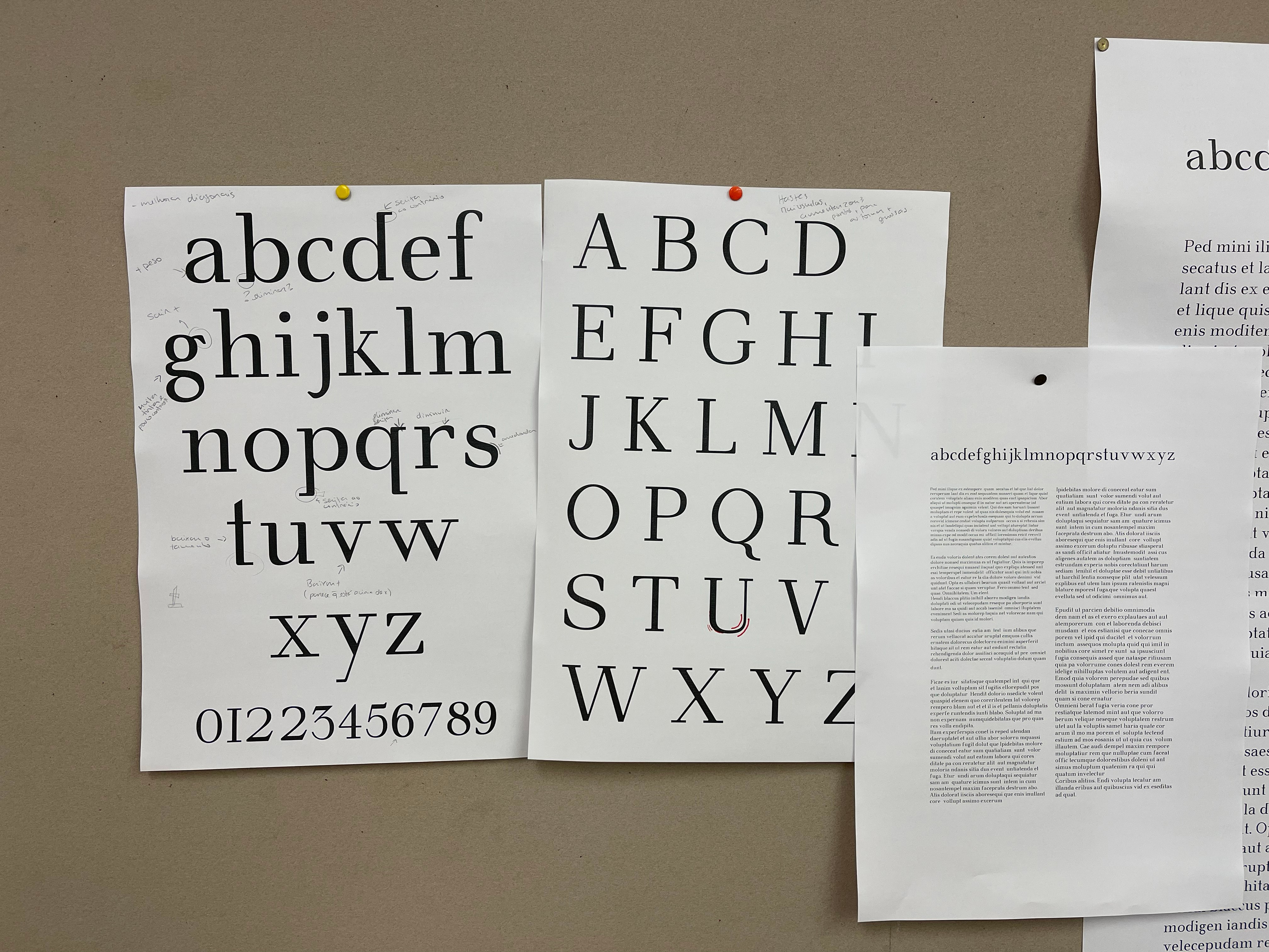 Graphic of a typography specimen showing the alphabet and numerals on top of a dark gray background.